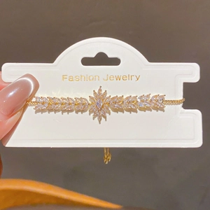 Close-up of 18k gold plated flower bracelet with water drop pendant and zircon crystals