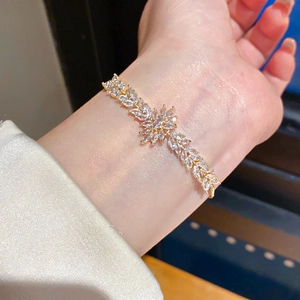 Macro detail of 18k gold plated flower bracelet with marquise zircon stones and slider clasp