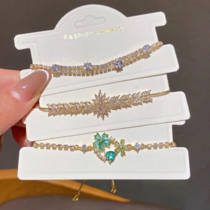 Set of three 18k gold plated flower and water drop bracelets with sparkling zircons