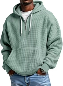 Détail de la texture gaufrée et de l'encolure à quart de zip du sweat à capuche vert menthe
