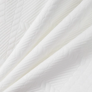 Gros plan détaillé du tissu en maille jacquard blanc avec motif à chevrons texturé