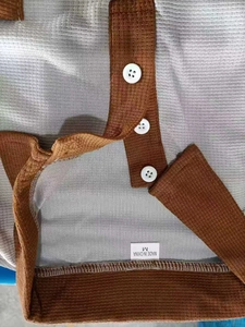 Detail of waffle knit fabric texture on contrast polo collar and button placket