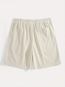 Detailed macro view of heavy waffle knit texture and elastic waist on men's cotton shorts