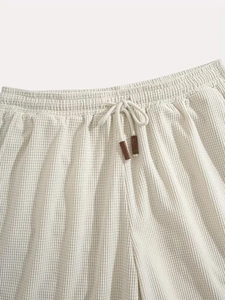 Macro detail of men's waffle knit shorts waist with elastic band and premium drawstring