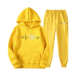 Yellow tracksuit set with hoodie and joggers featuring heartbeat and heart print patterns