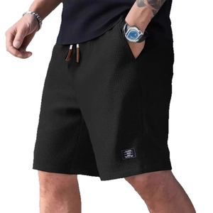Men's heavy black waffle knit shorts with elastic drawstring waist and side pockets