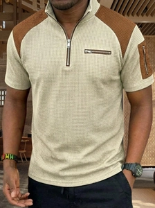 Close-up of waffle texture fabric and decorative zipper pockets on men's polo shirt