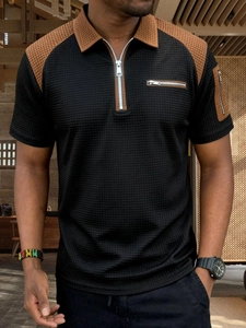 Detailed view of men's polo shirt with brown waffle knit patches and zipper pockets