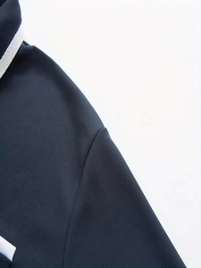 Detailed close-up showing breathable piqué fabric texture and shoulder seams of a polo shirt