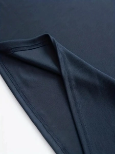 Macro view of breathable navy blue pique knit fabric with durable double-stitched hem