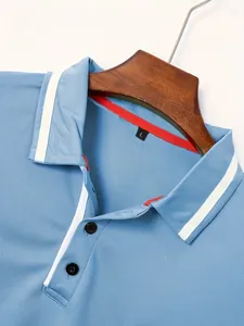 Detail of light blue cotton Polo shirt featuring white stripe trim and red neck tape