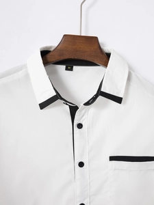 Detail of white slim fit shirt featuring black contrast piping, M size label, and wooden hanger