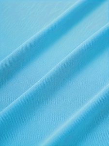 Close-up of light blue polo shirt featuring breathable mesh knit fabric texture