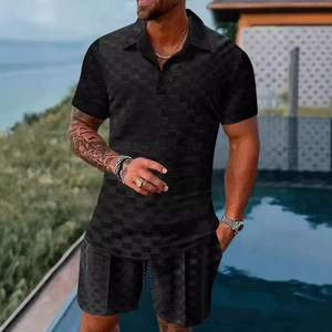 Detail view of men's polo set with black checkerboard jacquard texture in poolside setting