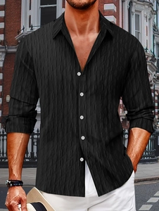 Close-up of black men's cotton shirt with diamond jacquard texture and white buttons