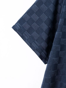Detailed macro view of navy blue ice silk fabric with checkerboard jacquard texture