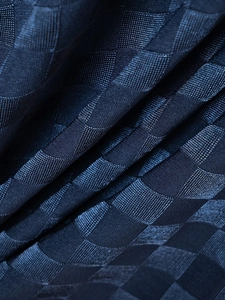 Macro shot of navy ice silk fabric showing intricate checkered jacquard weave texture