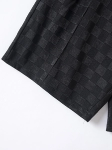 Macro shot of black checkerboard textured jacquard fabric on summer sports set