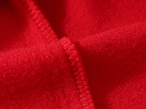 Close-up of red fleece inner lining with high-quality overlock stitching detail