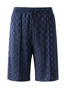 Detail of dark blue checkered jacquard shorts with elastic drawstring and pleats