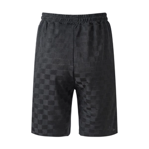 Detail view of men's black ice silk shorts with checkerboard jacquard and elastic waist