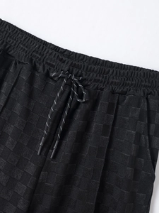 Close-up of checkerboard knit texture on men's ice silk shorts with elastic drawstring waist