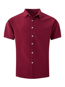 Detail of waffle textured fabric and contrast buttons on burgundy short sleeve shirt