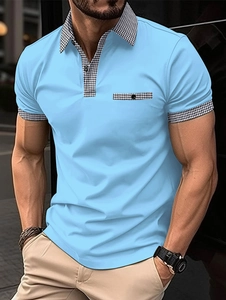 Detail of light blue men's polo shirt featuring houndstitch pattern on pocket and collar