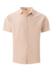 Detail of waffle knit texture on beige short sleeve shirt with white buttons and collar