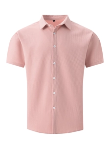 Close-up of light pink short sleeve shirt showing waffle texture and white buttons