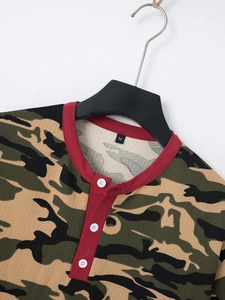 Detail of waffle knit fabric and red trim collar on men's camouflage polo shirt