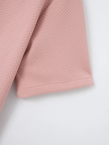 Close-up of pink waffle knit fabric showing premium texture and durable stitching detail