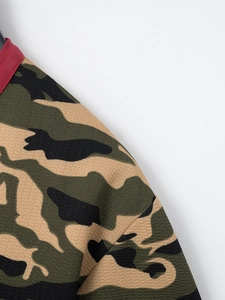 Close-up of military camouflage polo shirt with waffle texture and red collar trim