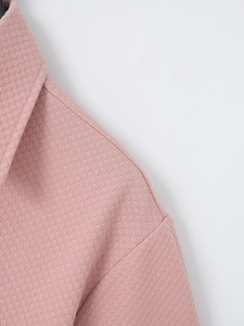 Detailed view of pink men's shirt with waffle texture fabric and clean stitching