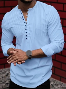 Close-up of light blue men's Henley shirt featuring vertical pleats and decorative buttons