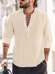 Detail of beige textured cotton linen shirt featuring vertical pleats and multiple buttons