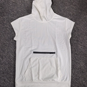 Close-up of white sleeveless sports hoodie with black zipper detail and front pocket