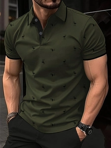 Close-up of olive green Polo shirt featuring flamingo print and black contrast collar details