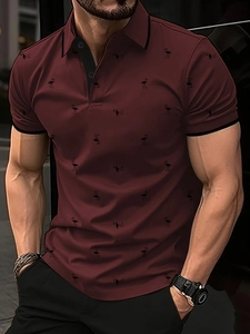Detail of burgundy Polo shirt with black flamingo print and contrasting collar and cuffs
