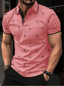 Detailed close-up of coral pink men's polo shirt featuring black flamingo pattern prints