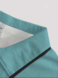 Close-up of teal polo shirt collar with black piping detail and polyester fabric texture