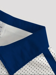 Close-up of contrast polo collar with polka dot pattern and durable polyester fabric