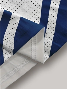 Detailed close-up of breathable mesh fabric and double-stitched hem on the polo shirt