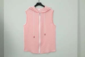 Close-up of pink hooded sleeveless vest with waffle texture and metal ring zipper puller