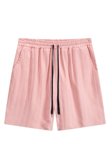 Detail view of pink men's casual shorts showing waffle knit texture and drawstring waist
