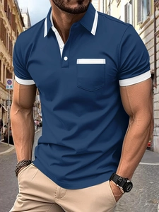 Detail of slim-fit men's navy blue polo shirt with white trim on collar and chest pocket