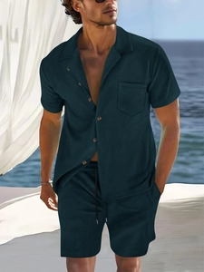 Close-up of men's summer resort set featuring deep teal ribbed texture and buttoned shirt