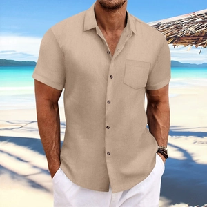 Men's khaki striped short sleeve shirt with ribbed texture and chest pocket on a beach