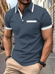 Detail of navy blue polo shirt featuring a white collar and chest pocket decoration