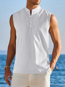 Detailed texture of men's white mandarin collar sleeveless shirt on a beach background